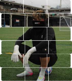 Goalkeeper kneeling on turf wearing gloves at urban field